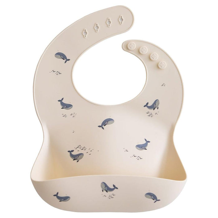 
    Babador De Silicone Infantil Mushie Whales - Mushie Babytunes
  