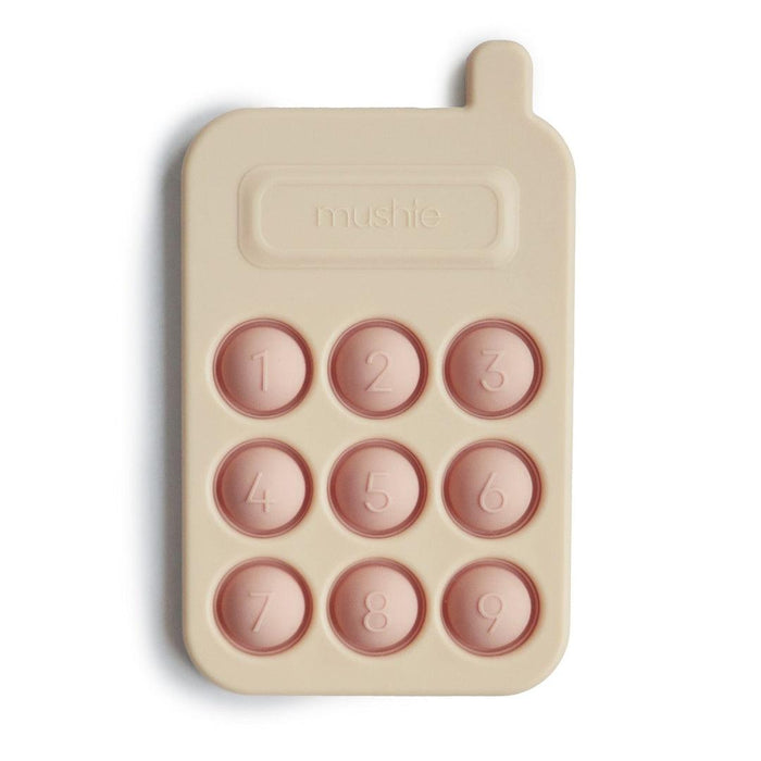 
    Brinquedo Telefone Press Toy Mushie Blush - Mushie Babytunes
  